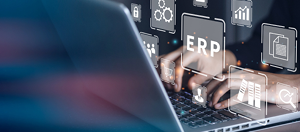 hands on a laptop keyboard are typing - ERP written out