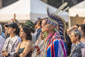 Toronto Ontario, Canada- June 7th, 2023: A native Canadian listening to a speech about refugees while Little Amal is at Toronto City Hall during the Luminato Festival.