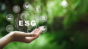 ESG icon concept in the hand for environmental, social, and governance in sustainable and ethical business on the Network connection on a green background.